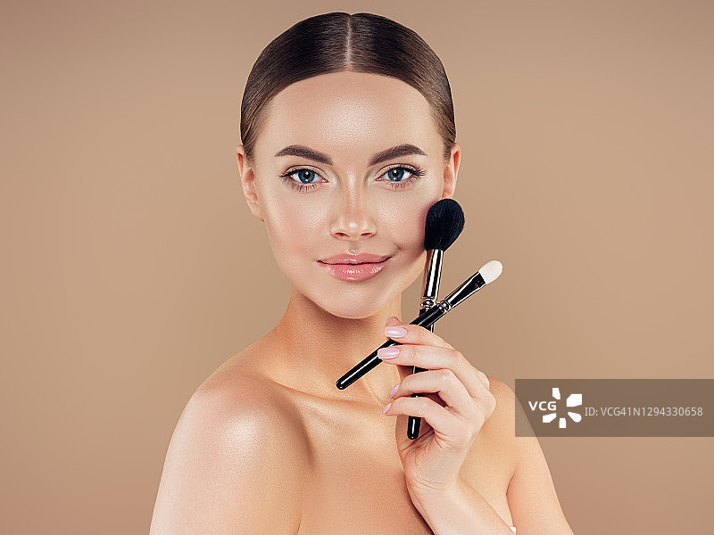 年轻女子涂抹粉底图片素材