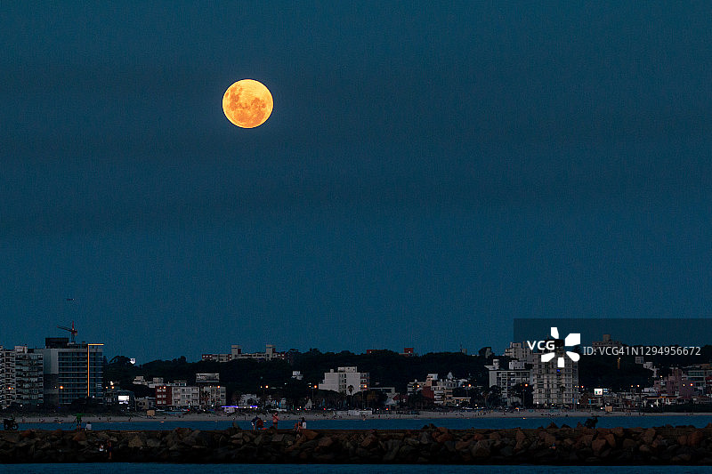 乌拉圭马尔文海滩，蒙得维的亚上空的满月图片素材