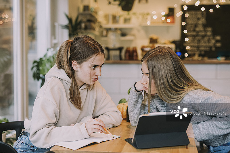 在咖啡馆学习的两名青少年图片素材
