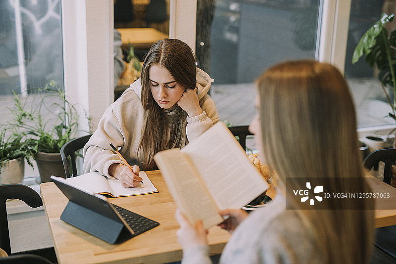 在咖啡馆学习的两名青少年图片素材