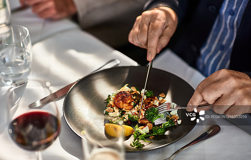 男人在餐厅享用新鲜烹饪的食物图片素材