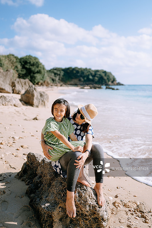 年轻女孩和母亲在日本海滩上图片素材