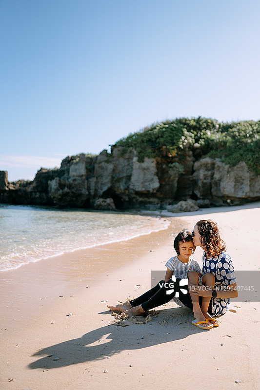 年轻女孩和母亲在日本海滩上图片素材