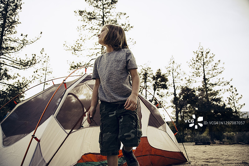 低角度视角：男孩站在帐篷前图片素材