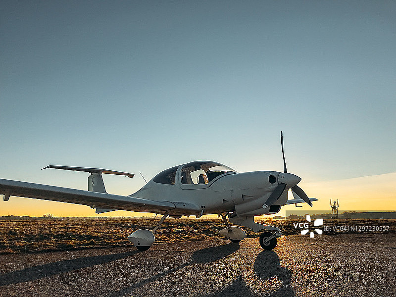 日落时分停放的单引擎螺旋桨小型飞机图片素材