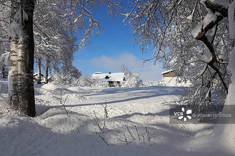 巴伐利亚小镇的冬季雪景：古老的农舍覆盖着白雪图片素材