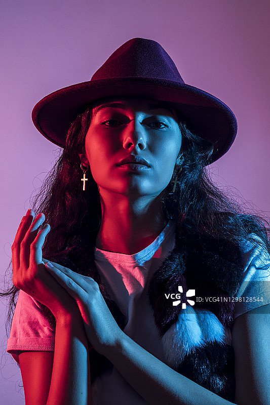 紫色背景下戴帽子的少女特写图片素材