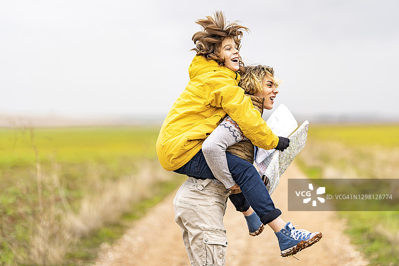 年轻男子在徒步旅行时背着弟弟图片素材