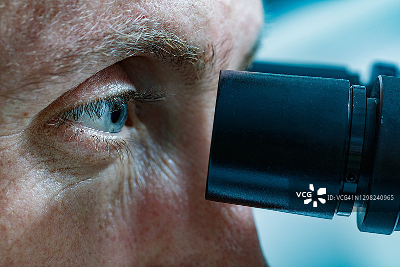 男科学家使用显微镜工作特写图片素材