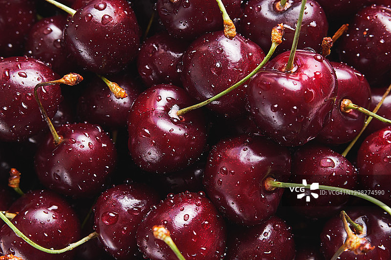 铁盘或滤盆中带水滴的红色成熟樱桃背景图片素材