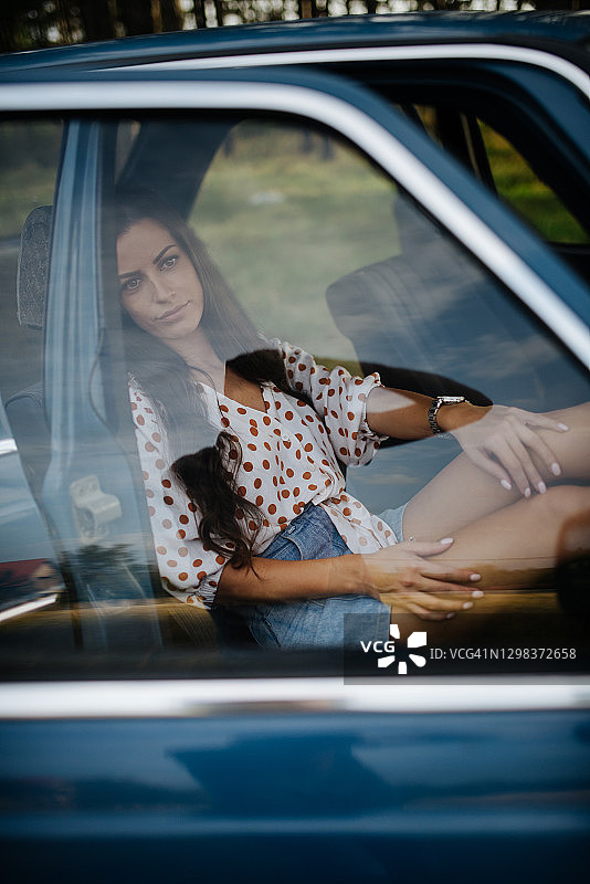 疲惫的女司机坐在她的老爷车里图片素材