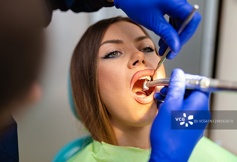 年轻女人接受牙科检查图片素材