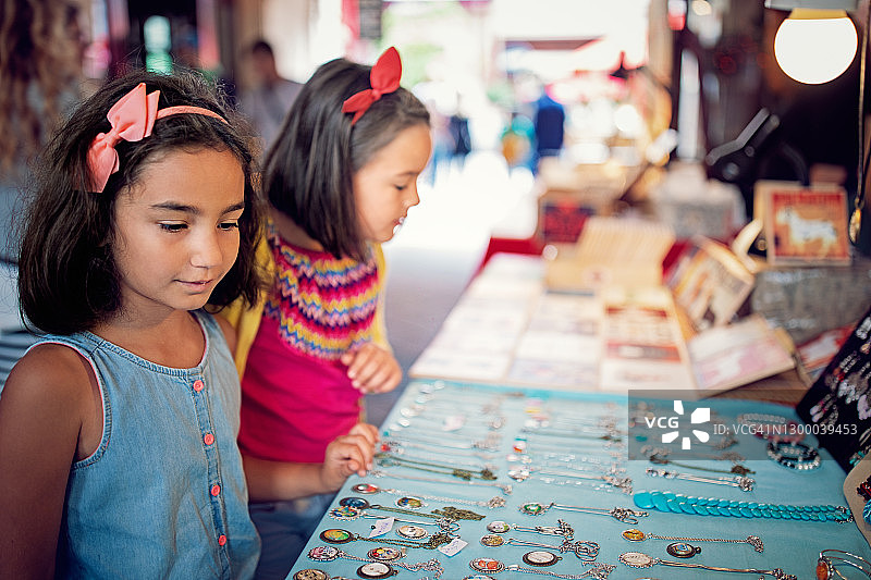 女友们在市场摊位上挑选礼物图片素材