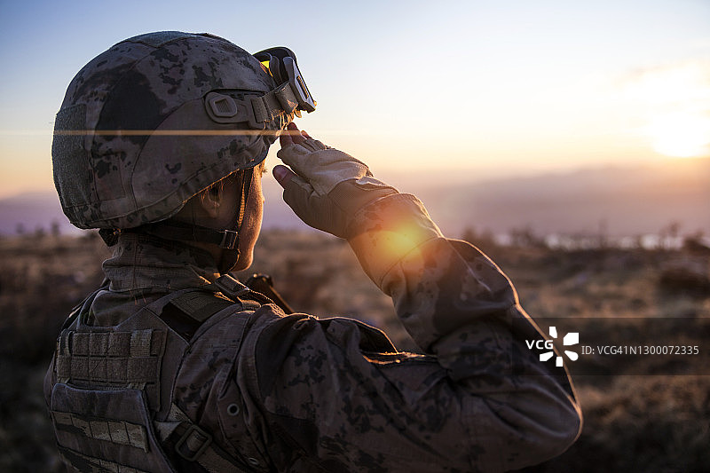 夕阳下敬礼的女陆军士兵图片素材