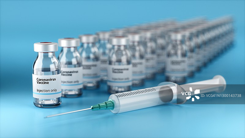 蓝色背景上的注射器和药瓶图片素材