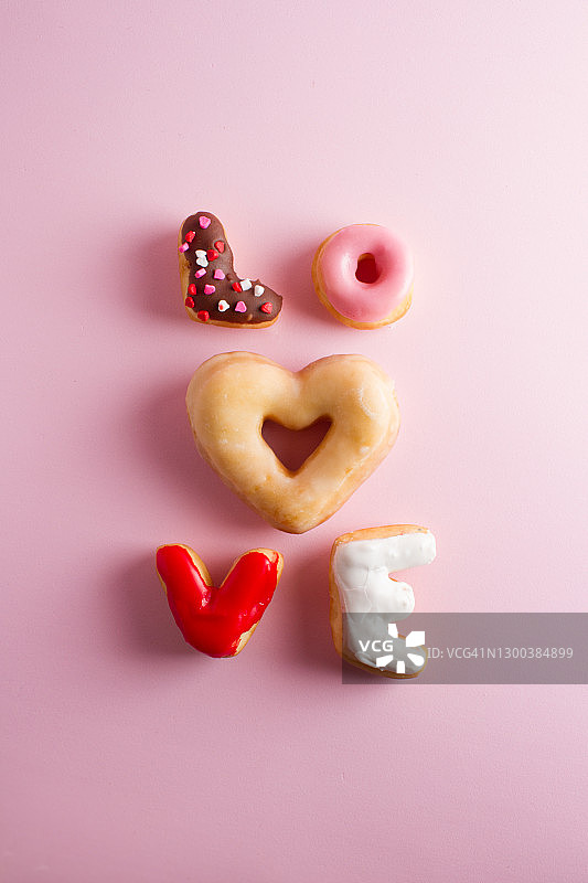 爱心甜甜圈，粉色背景情人节图片素材
