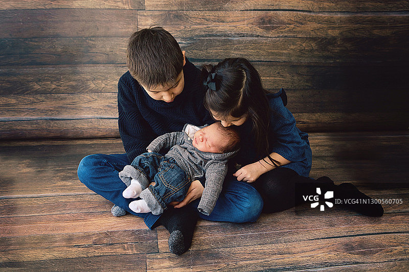 男孩和女孩依偎着新生小弟弟图片素材