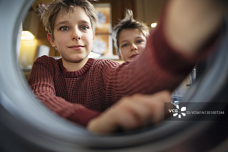 两个男孩在装洗衣机图片素材