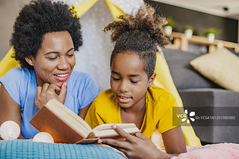 非裔美国母亲给女儿读书图片素材