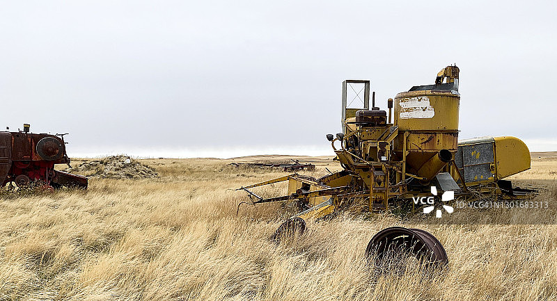 废弃农场上的旧联合收割机图片素材