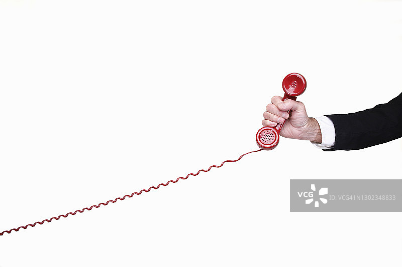 商人手持红色电话图片素材