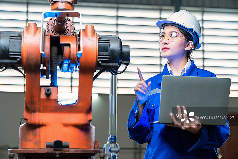 年轻女子在实验室检查机器人零件图片素材