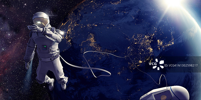 宇航员在太空行走，在地球前自拍图片素材