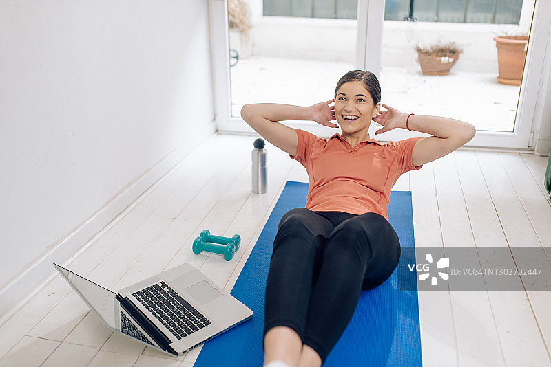 年轻女人喜欢在家锻炼图片素材