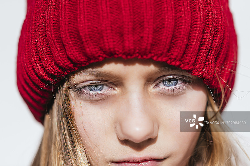 戴针织帽靠墙沉思的女孩图片素材