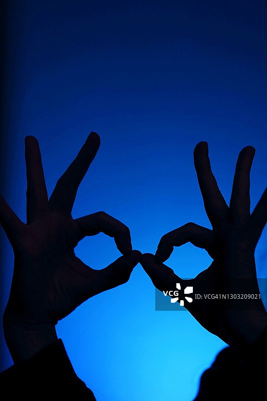 蓝色背景中的手部轮廓图片素材