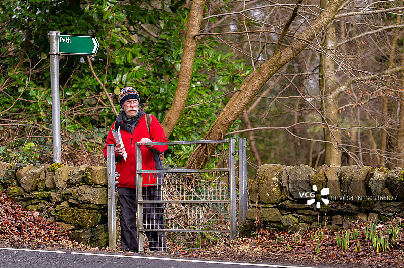 打开人行道大门的年长男人图片素材