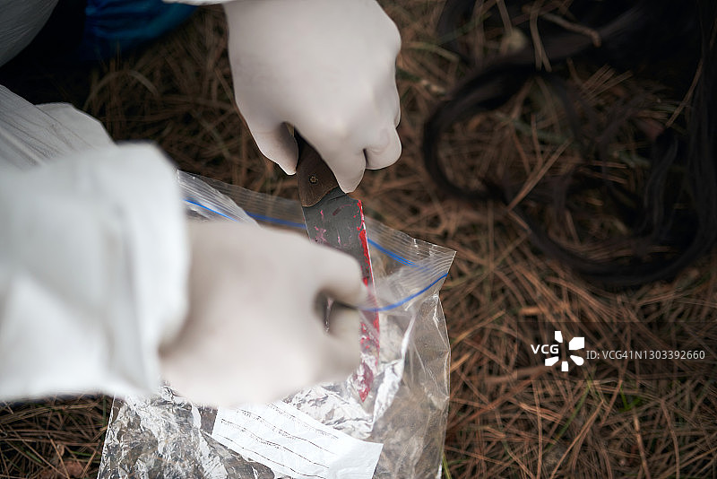 将犯罪现场的证据放入塑料袋中图片素材
