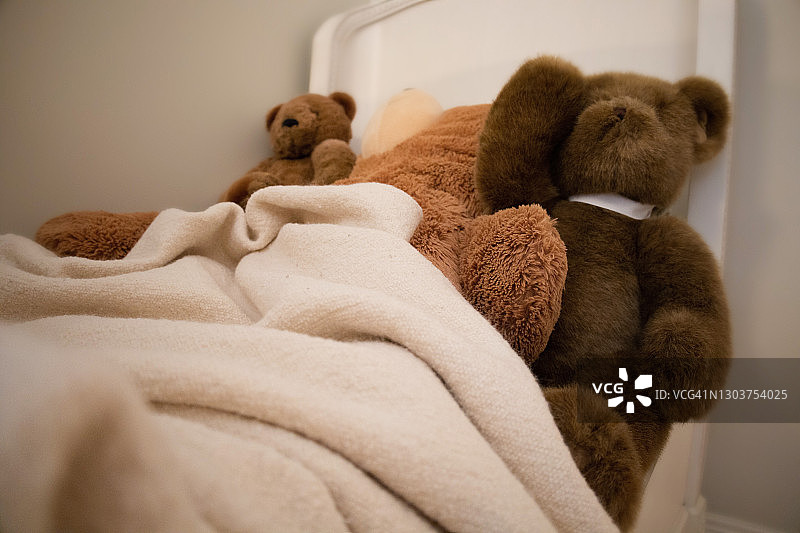 小女孩床上三个超大号毛绒玩具泰迪熊图片素材