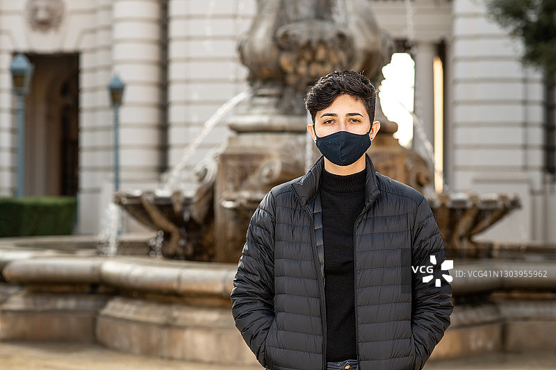 在喷泉前戴口罩的女子图片素材