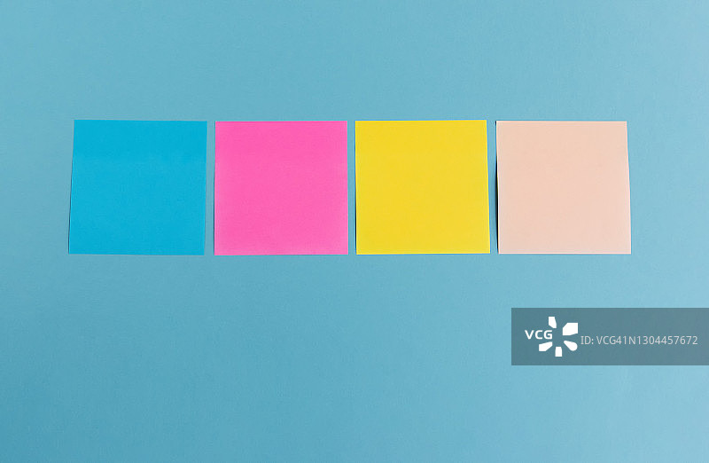 蓝色背景上的彩色便利贴图片素材