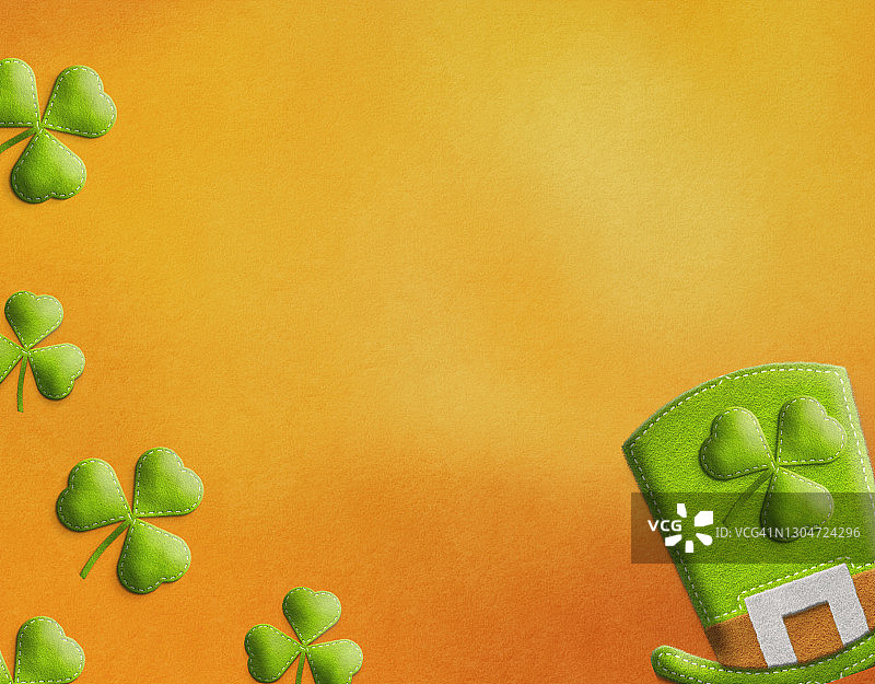圣帕特里克节横幅设计：爱尔兰精灵帽和带橙色文案区的三叶草叶子图片素材