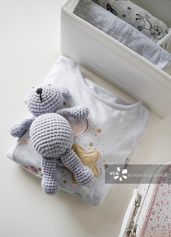 折叠的睡衣和蓝色泰迪熊图片素材