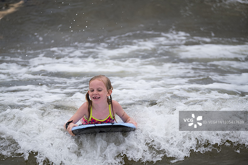 女孩在海滩上玩趴板图片素材