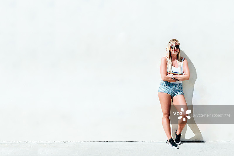 穿着短裤和条纹T恤的金发女人图片素材