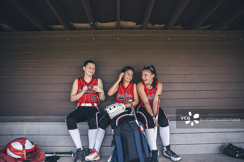 女子垒球队在休息区玩耍图片素材