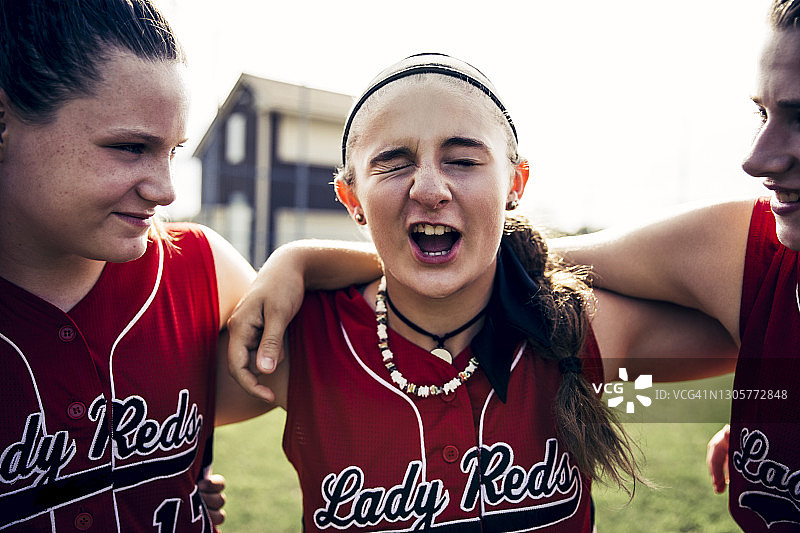 赛前在球场上围在一起的女子垒球队图片素材