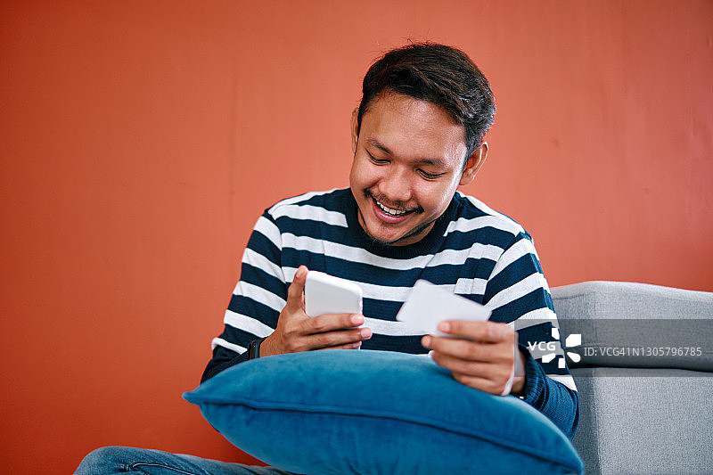 男人用手机信用卡购物图片素材