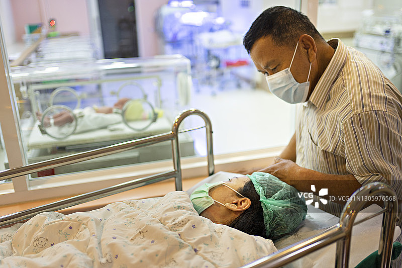 父亲在女儿分娩后看到孙辈时激动的时刻图片素材