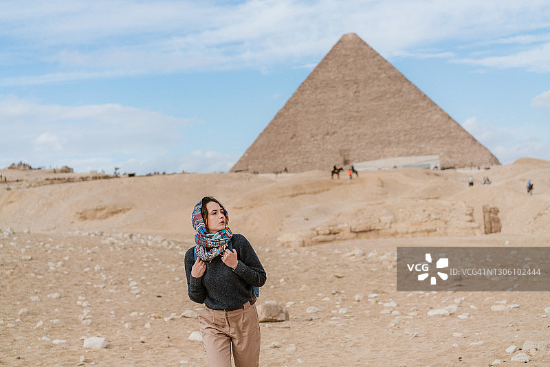 女人在吉萨金字塔附近行走图片素材