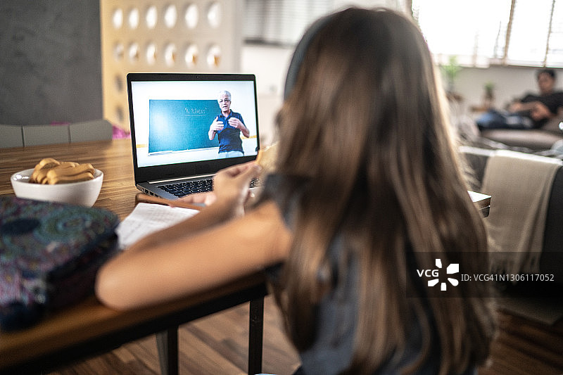 女孩在家用笔记本电脑上网课图片素材