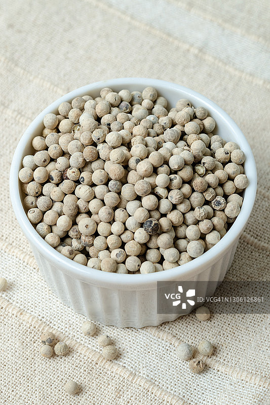 乡村木桌上的陶瓷碗装有机白胡椒图片素材