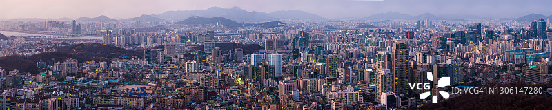 韩国首尔拥挤的城市天际线在黄昏时分灯火通明航拍全景图片素材