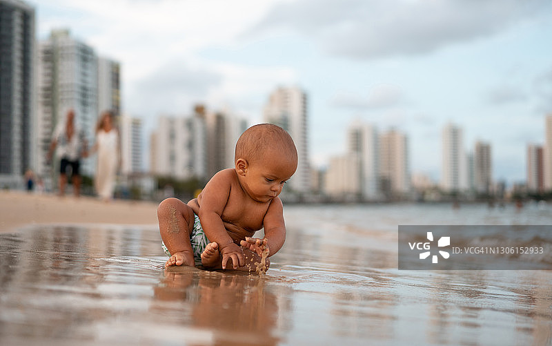 在岸边玩耍的男婴图片素材