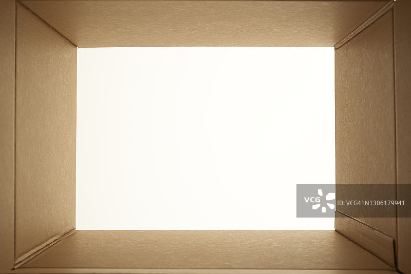 透过纸板打开的盒子看向白色背景图片素材