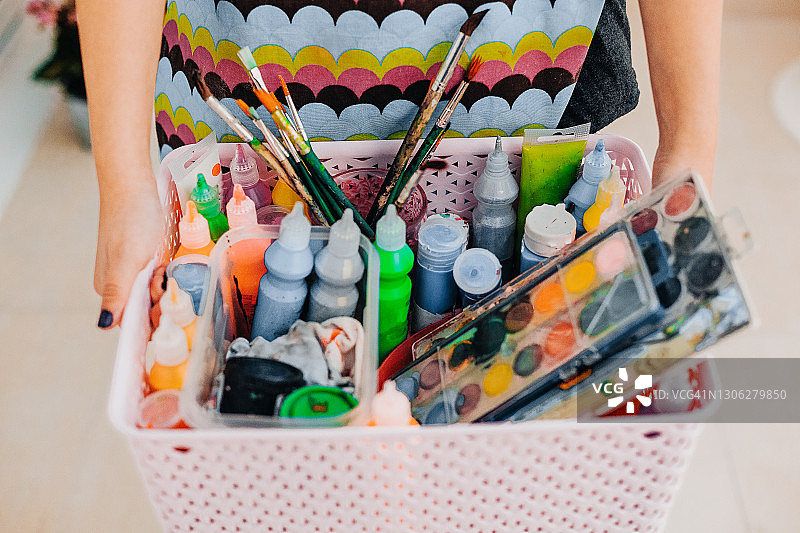 女人拿着装有美术用品的粉色盒子图片素材